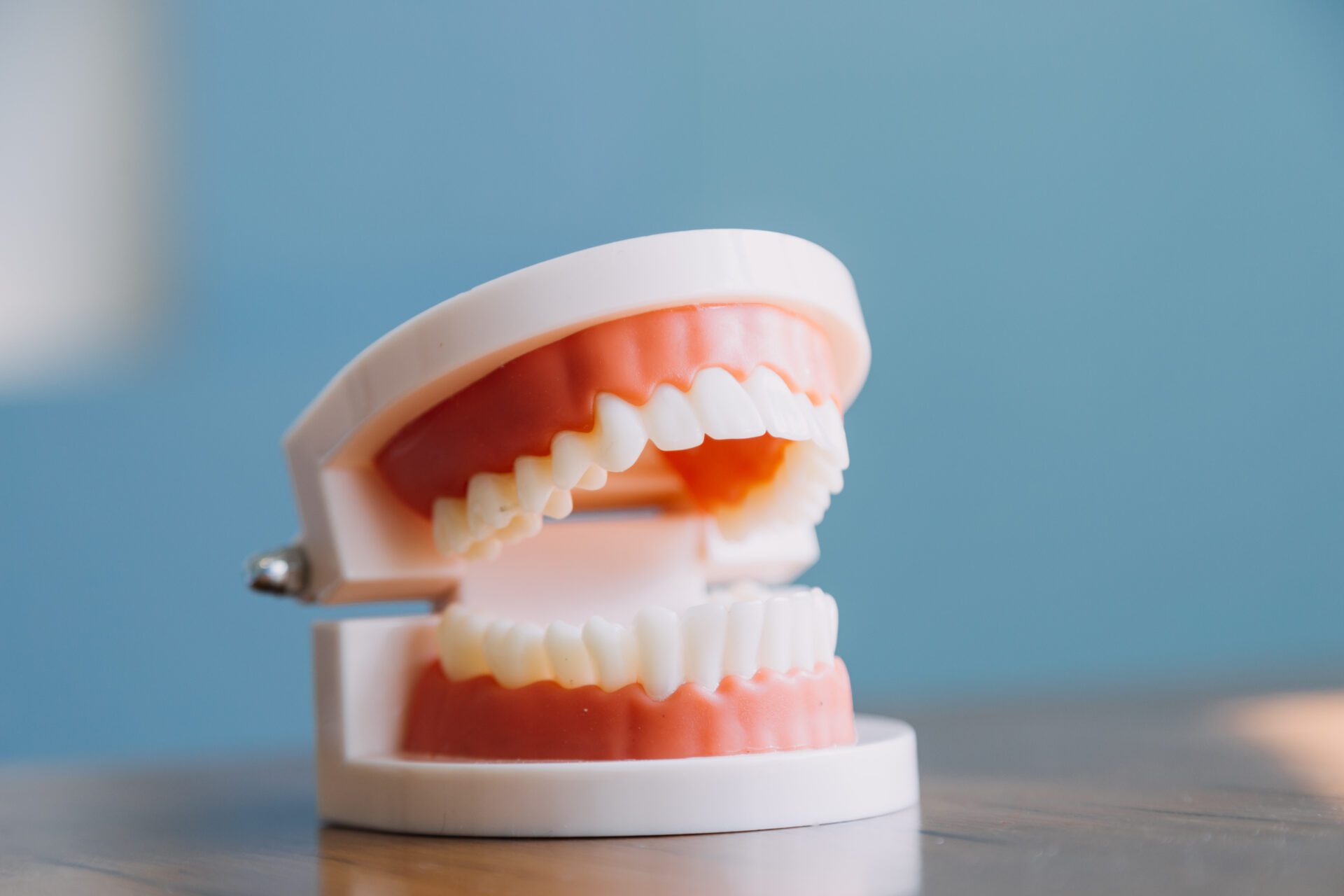 Stomatology concept, partial portrait of girl with strong white teeth looking at camera and smiling, fingers near face. Closeup of young woman at dentist's, studio, indoors